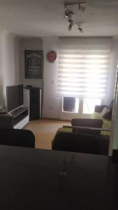 a living room with a couch and a tv and a window at Home St Nicolas Home VUT42/000161 in Soria