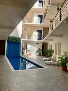 a pool in the middle of a building at Paradise Huatulco Condo TANGOLUNDA BEACH in Tangolunda