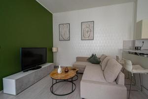 a living room with a couch and a tv at Ruterra Apartment Charles Bridge in Prague