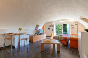 a living room with a couch and a table in a room at Casa di campagna Tony con piscina e vista lago in Gravedona