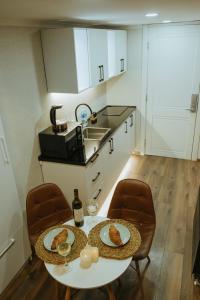 a kitchen with a table with two plates of food on it at Luxury Duplex Suites - City Center in Tbilisi City