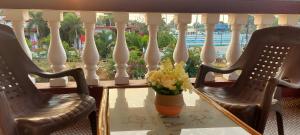 a table with a vase of flowers on a balcony at 'Golden Oceans' 3 bhk beach view villa in Benaulim