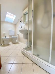 a bathroom with a shower and a toilet and a sink at Albergo Villa Ada in Borgio Verezzi
