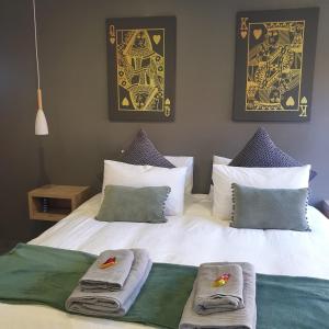 a bedroom with a bed with towels on it at @Lloyds in Ermelo