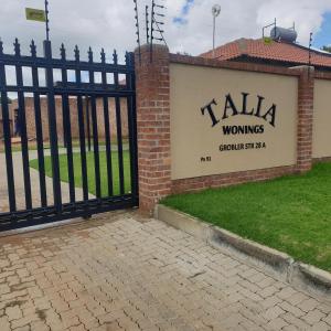 a gate with a sign that reads talkawolves at Lloyds - 3 in Ermelo +5 photos