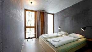 a bedroom with two beds and a large window at Bern Youth Hostel in Bern