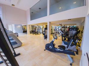 a gym with treadmills and ellipticals in a building at Garden Suites Pinamar in Pinamar