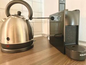 a tea kettle is sitting next to a microwave at Ferienwohnung Kirchbichl am Schliersee mit Terrasse in Schliersee