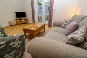 a living room with two couches and a coffee table at Pippas place in Penzance