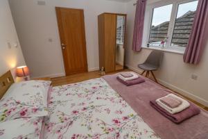 a bedroom with a bed with two towels on it at Pippas place in Penzance