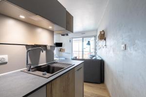 a kitchen with a sink and a counter top at À 50m de la Grande Plage, appartement pour 4 in Saint-Gilles-Croix-de-Vie