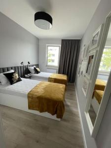 Posteľ alebo postele v izbe v ubytovaní Całkowicie nowy Apartament przy plaży