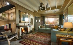 a living room with a couch and a fireplace at The Moorings, overlooking Loch Fyne in Cairndow