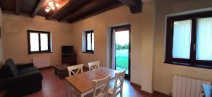 a living room with a table and chairs and a couch at EcoHotel Rural Angiz in Busturia
