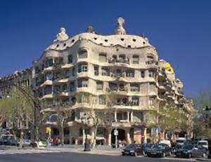 un grand bâtiment avec des voitures garées devant lui dans l'établissement Nisia B&B, à Barcelone