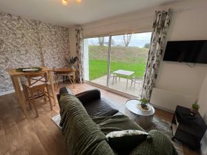 a living room with a couch and a table at Explorer in Betton