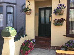 a front door of a house with flowers on it at The Benson Hotel in Blackpool