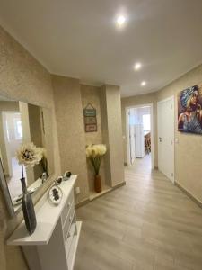 a bathroom with a sink and a counter with flowers at Monte Gordo apartment in Monte Gordo