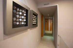 a hallway with two paintings on the wall at Hotel Bocage in Setúbal