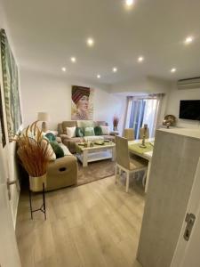 a living room with a couch and a table at Monte Gordo apartment in Monte Gordo