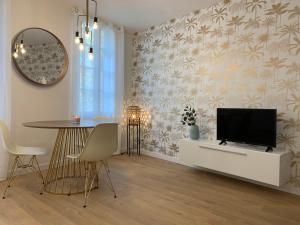 a living room with a tv and a table at Superbe appartement en hyper centre avec clim in Toulouse
