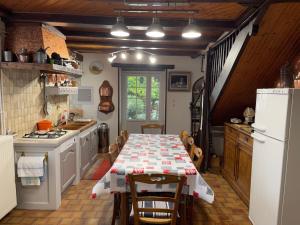 a kitchen with a table with a table cloth on it at Gite paisible a la Roche in Cercles