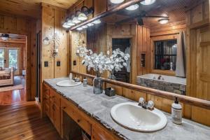 a bathroom with two sinks and a tub at River Wellness Lodge in Kingston
