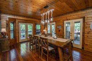 a dining room with a large wooden table and chairs at River Wellness Lodge in Kingston