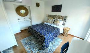 a bedroom with a bed with a blue and white bedspread at VFH Villa Flavia Eco B&B - 50 metri dal mare in Santa Flavia