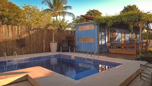 a small swimming pool next to a tiny house at Abrolhos Dive Inn in Caravelas