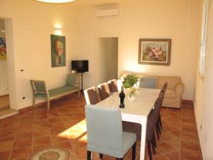 a dining room with a table and chairs and a couch at Holiday Home Quercitella by Interhome in Certaldo