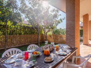 a wooden table with breakfast food on it at Holiday Home Dream House by Interhome in Follonica