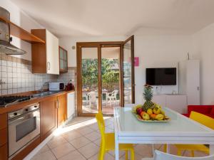 a kitchen with a table with a bowl of fruit on it at Holiday Home Dream House by Interhome in Follonica