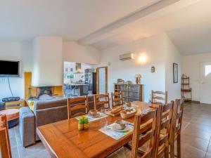 a dining room and kitchen with a wooden table and chairs at Holiday Home Villa Boccajo by Interhome in Porto-Vecchio