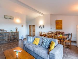 a living room with a couch and a table at Holiday Home Villa Boccajo by Interhome in Porto-Vecchio +23 photos