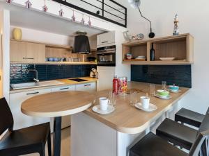 a kitchen with a wooden table and a dining room at Holiday Home La Corniche by Interhome in La Madrague