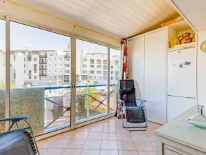 a kitchen with a balcony with a view of a pool at Apartment Les Jardins du Nil by Interhome in Cap d'Agde