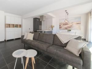 a living room with a couch and a kitchen at Apartment Miramar by Interhome in Ostend