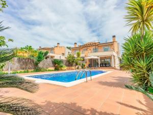 a villa with a swimming pool and a house at Holiday Home Francaset by Interhome in Roda de Bará