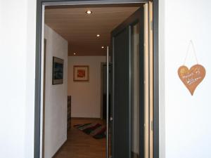 a door to a hallway with a heart sign on the wall at Apartment Kirchler by Interhome in Hippach