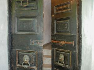 an old wooden door with two heads on it at Holiday Home Casa Signorile by Interhome in Peccia