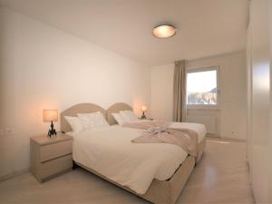 a bedroom with a large bed and a window at Apartment Chesa Sur Ova 22 by Interhome in St. Moritz