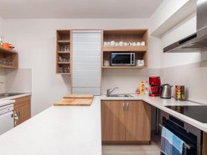 a kitchen with a sink and a microwave at Holiday Home Jelení kout by Interhome in Smržovka