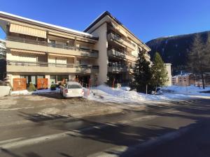 a white car parked in front of a building at Apartment Perla by Interhome in Davos