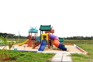 a playground with a slide in a field at Kiki's @ Palm Ridge-Vipingo in Kilifi