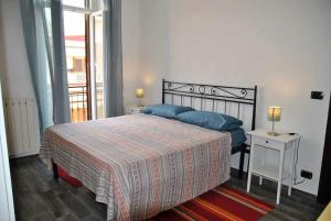 a bedroom with a large bed with blue pillows at TOP OF THE CITY Appartamento in centro in Formia