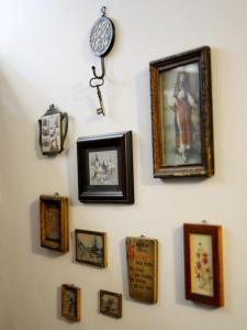 a wall with pictures and a clock on a wall at Casa Roth in Braşov