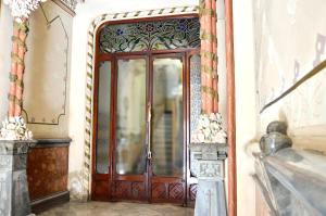 a wooden door in a room with a mirror at Way to BCN Casa Rovira in Barcelona