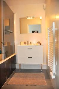 a bathroom with a white sink and a mirror at Appartement de 4 chambres a Canet en Roussillon a 100 m de la plage avec vue sur la mer terrasse amenagee et wifi in Canet-en-Roussillon