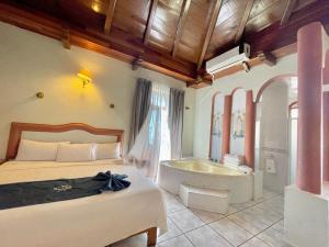 a bedroom with a bed and a bath tub at Hotel Frances in Guadalajara